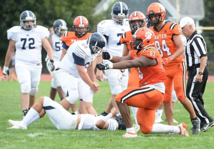 Thayer linemen Samson Okunlola (Brockton), sacks St. Mark's quarterback Tru Styles, during a game on Saturday, Sept. 25, 2021.